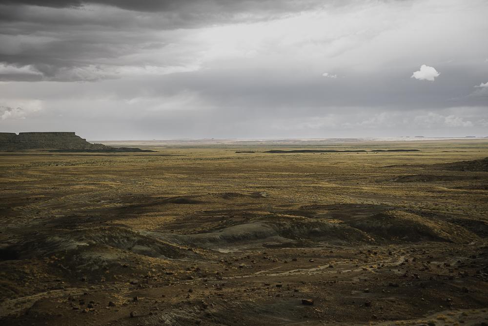 Expansive desert landscape beneath an approaching storm photographed by Rory Duffy