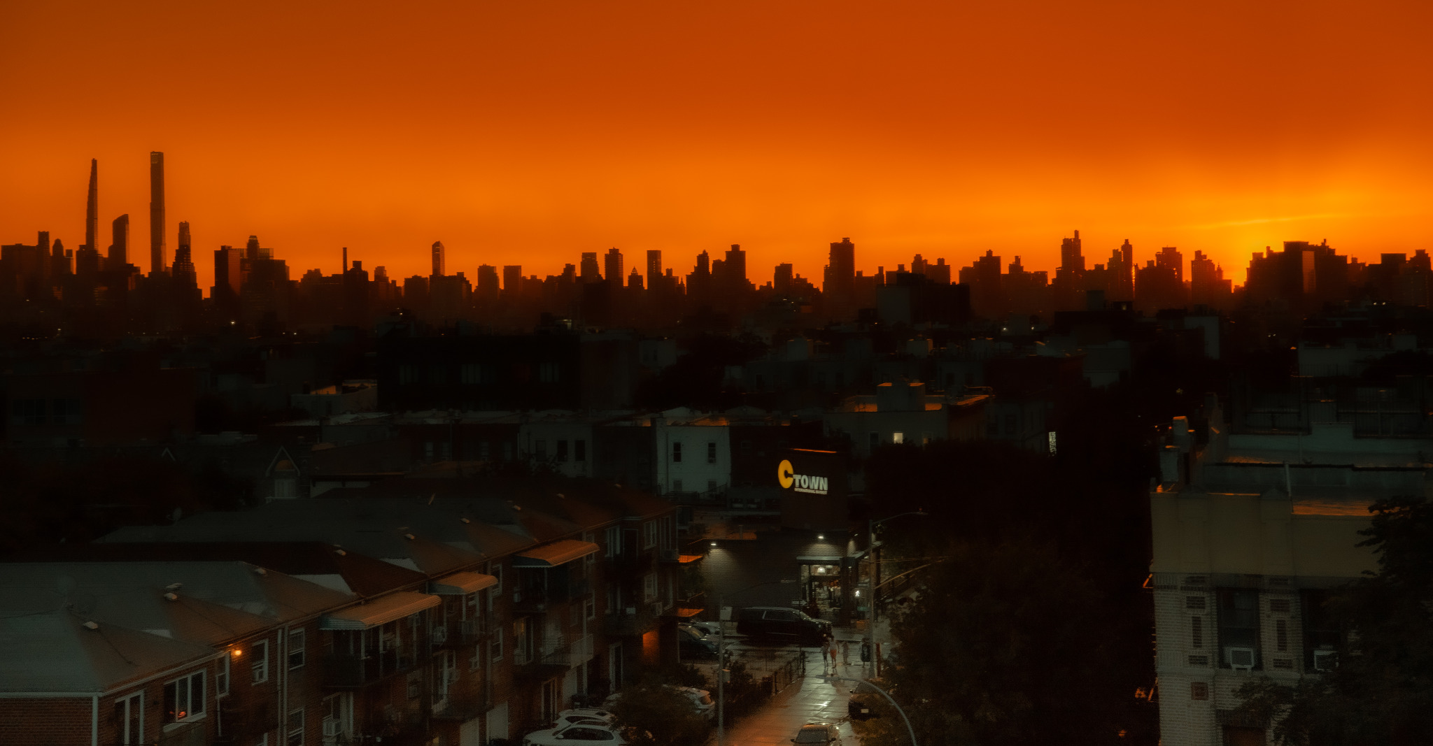 New York City skyline beneath a vivid orange sky photographed by Rory Duffy